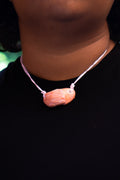 light pink ceramic necklace with a pendant replicating holding hands. Princess style necklace.